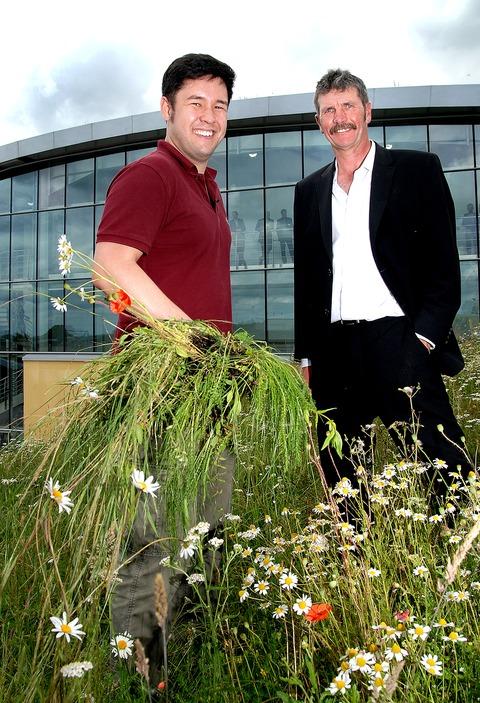 FLOWERS: Botanist James Wong with engineering director Clive Champion on the ‘living roof’ of the new Kanes Foods factory. Picture: Nick Toogood. 27080201