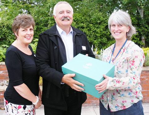 Christine Fleetwood and Phil Humphreys, of Pendragon Packaging, with Sarah Popplestone-Helm, of St Richard’s Hospice and one of the memory boxes.