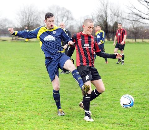 BATTLING FOR THE BALL: Red Horse (red and black shirts) face Powick last season before the former club quit competitive football, a problem that has concerned officials from the Worcester and District League.