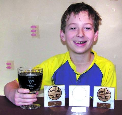 COUNTY STANDARD: Pershore Swimming Club's Chris Vizard, 10, celebrates an impressive Stourbridge Crystal Open display with a soft drink in the winner's goblet. His strong showing included a victory in the 50-metre backstroke. Picture: IAN PUGH