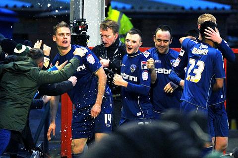 INSTANT ICON: Matt Smith (left) celebrates with his Oldham Athletic team-mates after scoring twice in his side’s 3-2 win over Liverpool in the FA Cup fourth round at Boundary Park on Sunday.