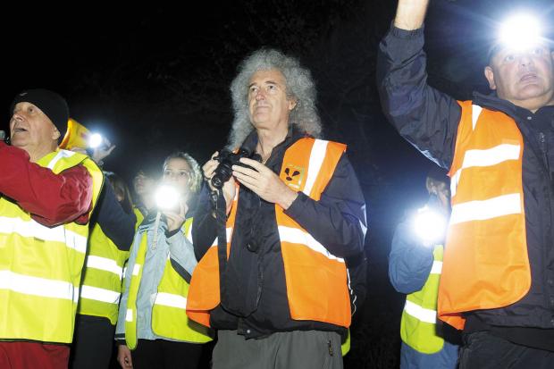 Tewkesbury Admag: SUPPORT: Queen guitarist Brian May, centre, got a warm round of applause when he met about 50 people taking part in one of the nightly Wounded Badger Patrols in Eldersfield. Tewkesbury Admag: SUPPORT: Queen guitarist Brian May, centre, got a warm round of applause when he met about 50 people taking part in one of the nightly Wounded Badger Patrols in Eldersfield.