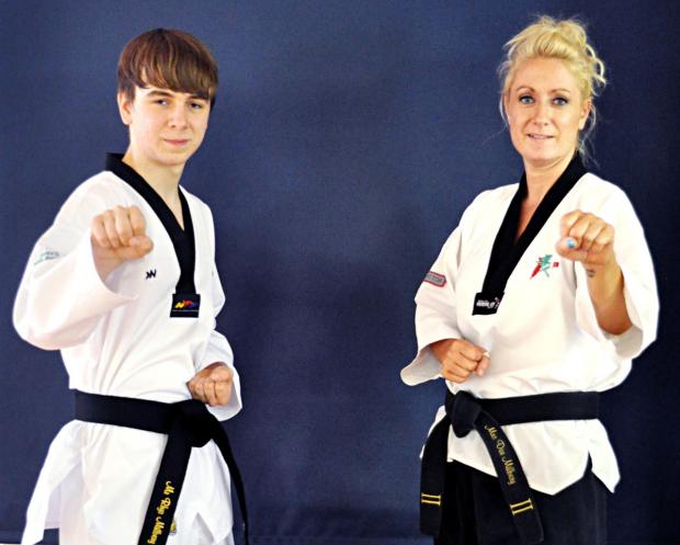 Tewkesbury Admag: BLACK BELTS: Aston Somerville son and mother Rhys and Dee Milbery have both attained the honour as members of London Chinatown Taekwondo. Picture: NEIL HALL Tewkesbury Admag: BLACK BELTS: Aston Somerville son and mother Rhys and Dee Milbery have both attained the honour as members of London Chinatown Taekwondo. Picture: NEIL HALL