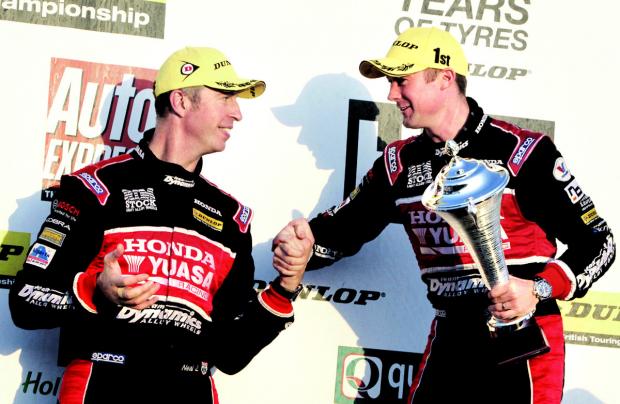 ON THE PODIUM: Winner Gordon Shedden, right, and Matt Neal enjoy the celebrations after race three at Silverstone but face a battle to grab the British Touring Car Championship title at Brands Hatch. Picture: DARREN PRICE.