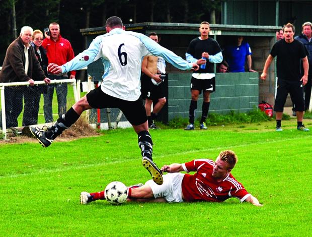 MY BALL: Littleton’s Nathan Hayward slides in against Pelsall Villa. Picture: MICHAEL PITTS.