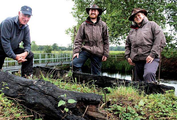 BRIDGE TO THE PAST: From left, Ted Rice, Hugh Warwick and garden and park manager Katherine Alker with sections of the lost Chinese-style bridge in parkland at Croome.