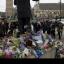 Flowers and tributes beside the Nelson Mandela statue in Parliament Square