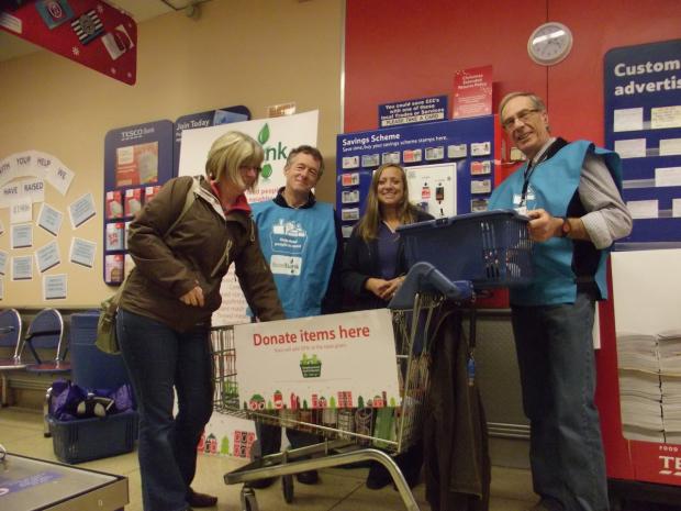 Tewkesbury Admag: Stocking up: Volunteer Andrew Beadle, with Tesco employee Sandra Davies, fellow volunteer David Meredith with shopper Jackie Jones. Tewkesbury Admag: Stocking up: Volunteer Andrew Beadle, with Tesco employee Sandra Davies, fellow volunteer David Meredith with shopper Jackie Jones.