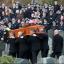 Fellow police officers attend the funeral of Pc Tony Collins, as his coffin is carried for burial at Lamlash Cemetery on the Isle of Arran